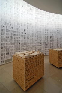 Invitation to the opening of the exhibition Eduardo Souto Moura: Competitions - Exhibition of Souto de Moura in Porto: The main exhibition room covered with sketches and mobile boxes with models - foto: Petr Šmídek, 2011