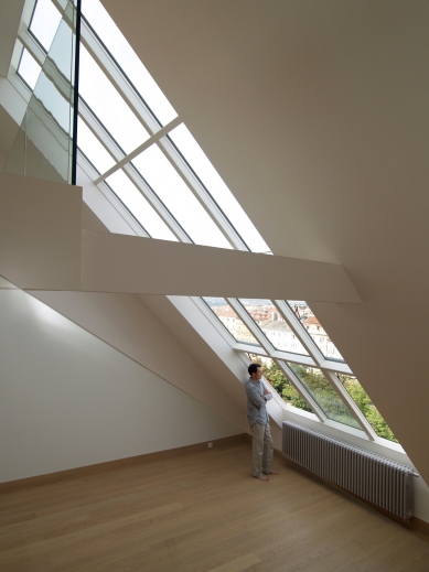 Attic roof windows in a family villa, vineyard house, and unique rooftop apartment - Roof studio glazing Solara VARIATIK over two floors of a maisonette apartment in Vinohrady