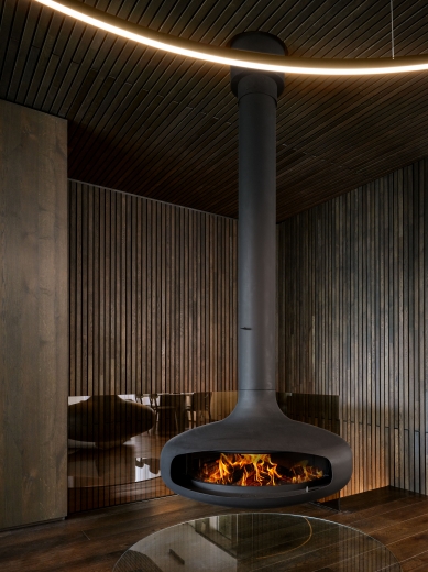 Iconic fireplace as a dominant feature of contemporary mountain architecture
